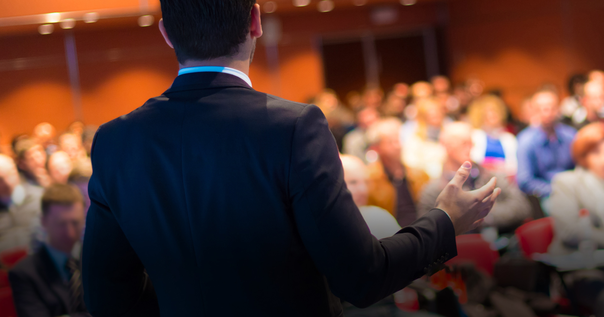 Speaker presenting to a conference audience